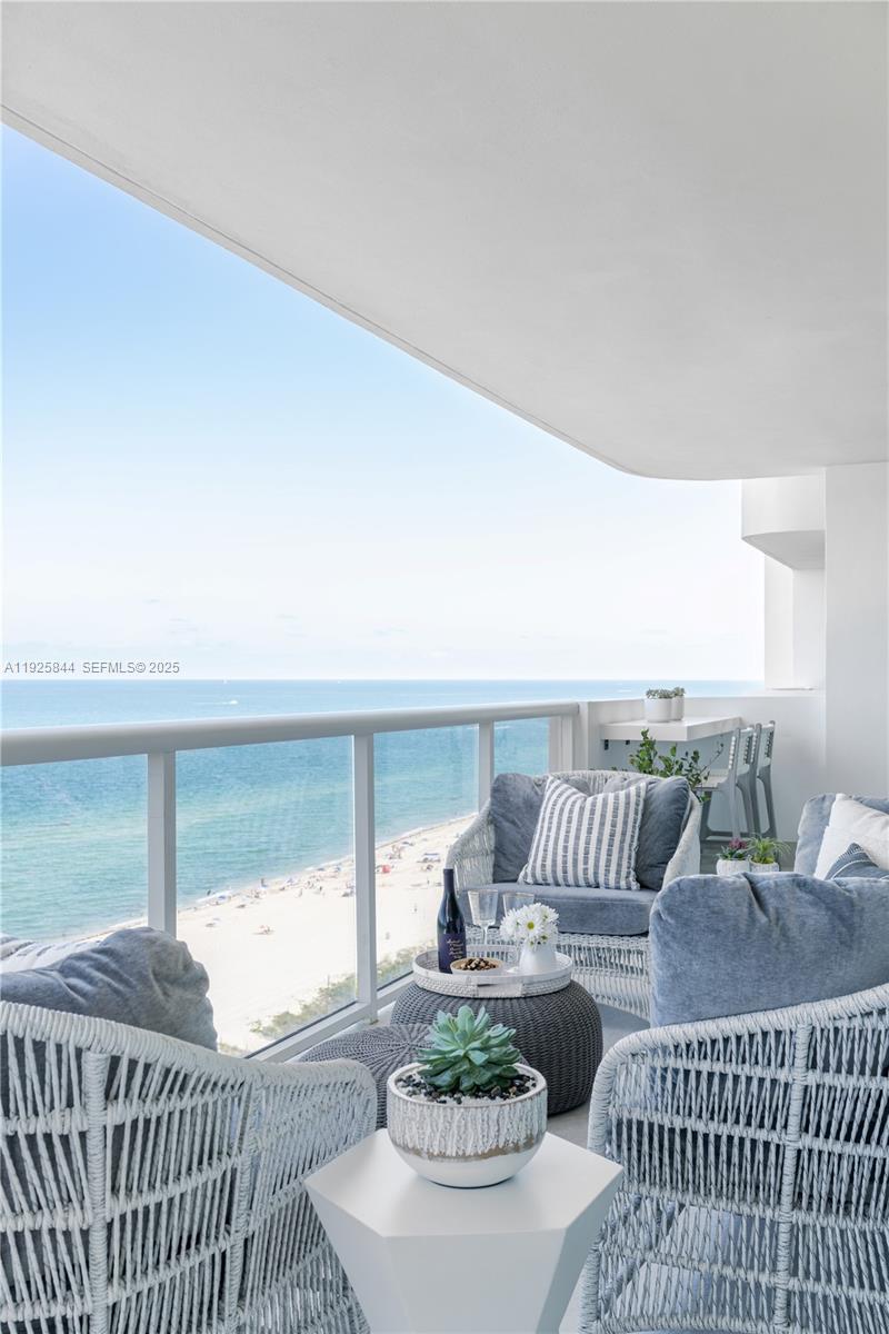 5757 Collins Avenue, Unit 1706 Miami Beach, FL 33140 - Photo 7 of 20 a living room with furniture and a large window