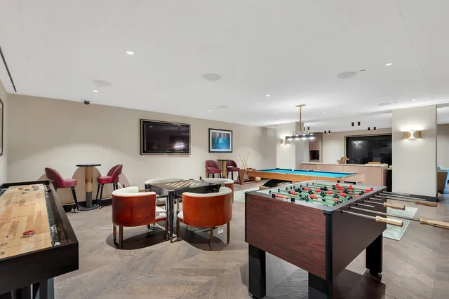 a large white kitchen with kitchen island a large window