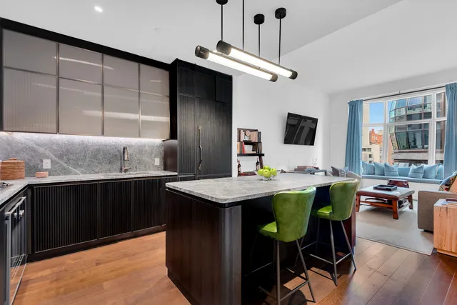 a large bed sitting in a bedroom next to a window