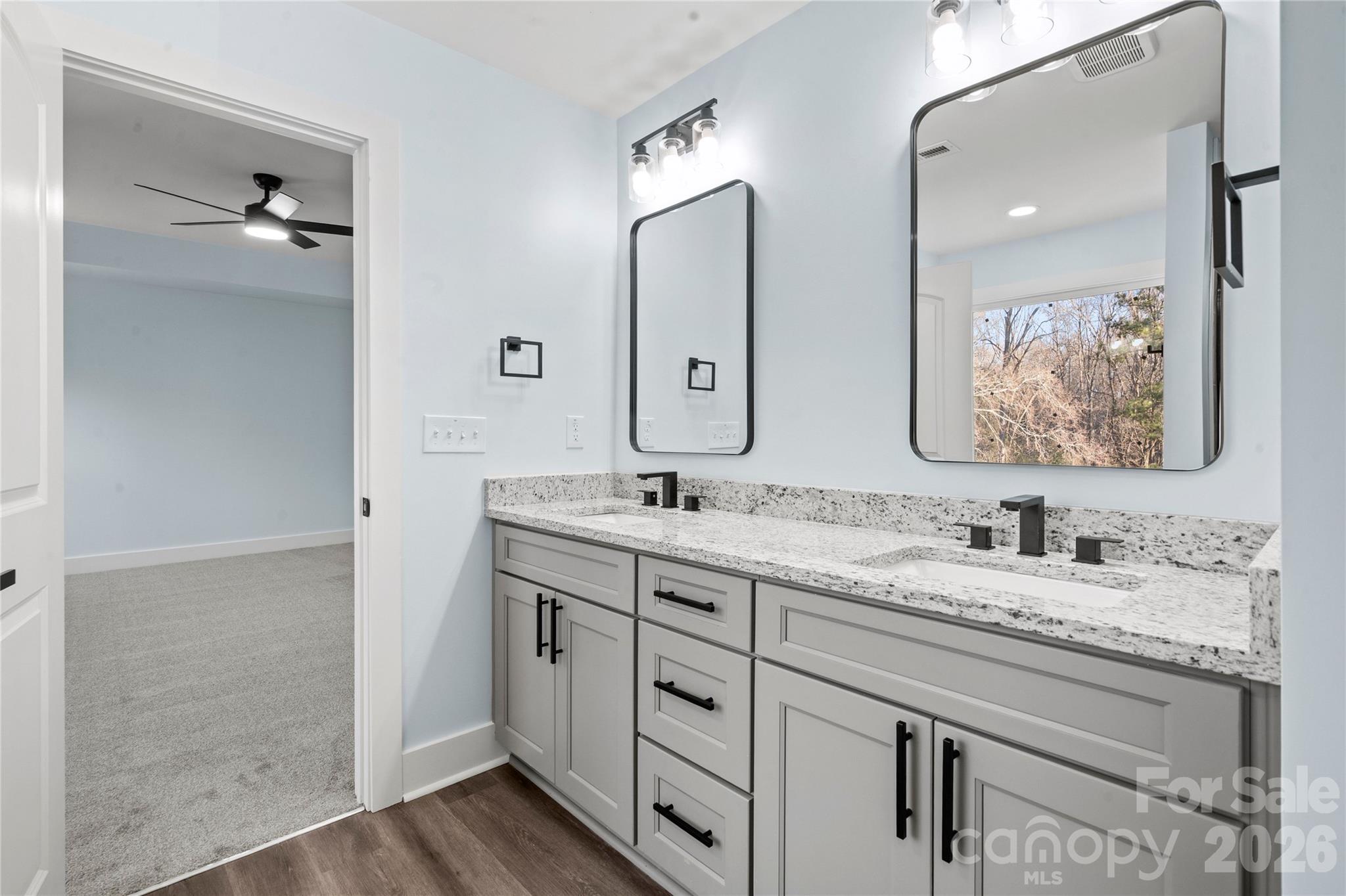 4524 Orphanage Road Concord, NC 28027 - Photo 12 of 29 a bathroom with double vanity sinks and a mirror