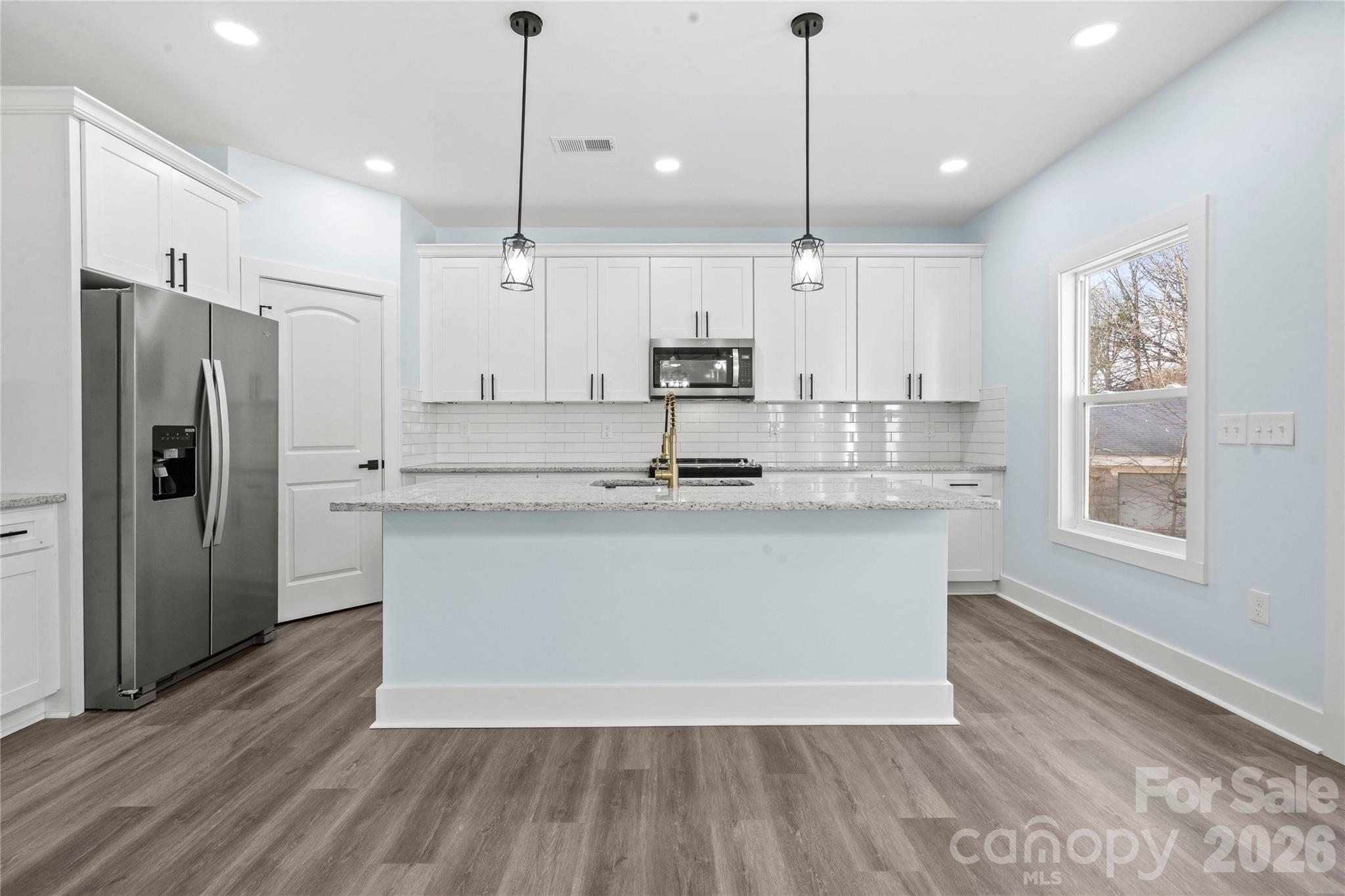 4524 Orphanage Road Concord, NC 28027 - Photo 18 of 29 a kitchen with kitchen island a counter top space a sink appliances and a window