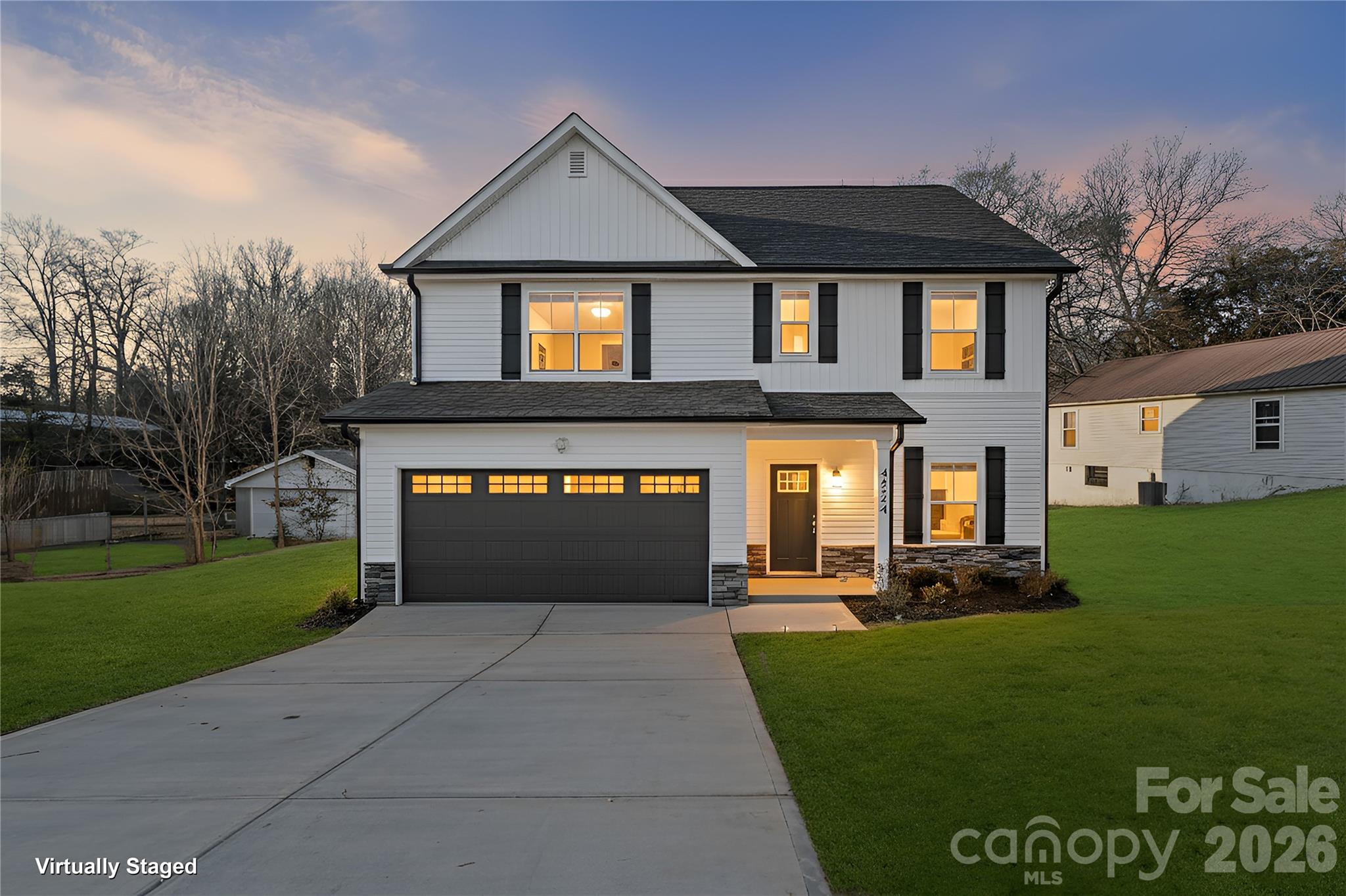 4524 Orphanage Road Concord, NC 28027 - Photo 2 of 29 a front view of a house with a garden and yard