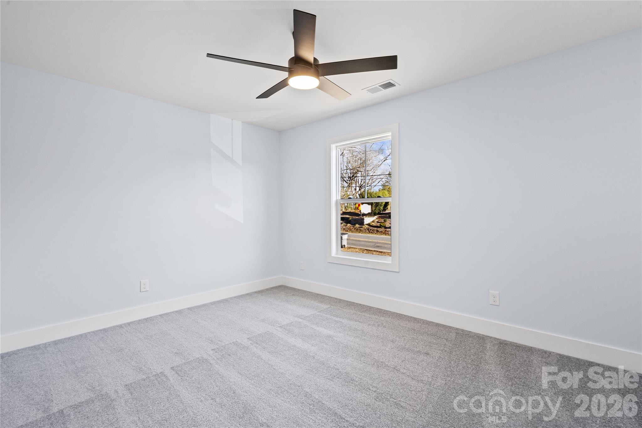 4524 Orphanage Road Concord, NC 28027 - Photo 3 of 29 an empty room with windows and ceiling fan