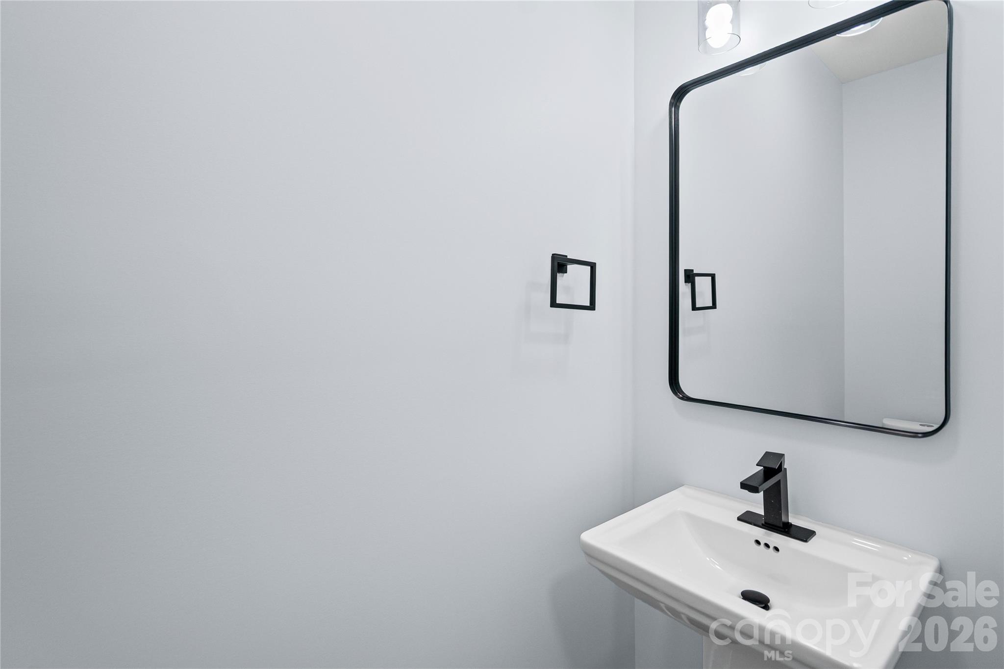 4524 Orphanage Road Concord, NC 28027 - Photo 5 of 29 a bathroom with a sink and mirror