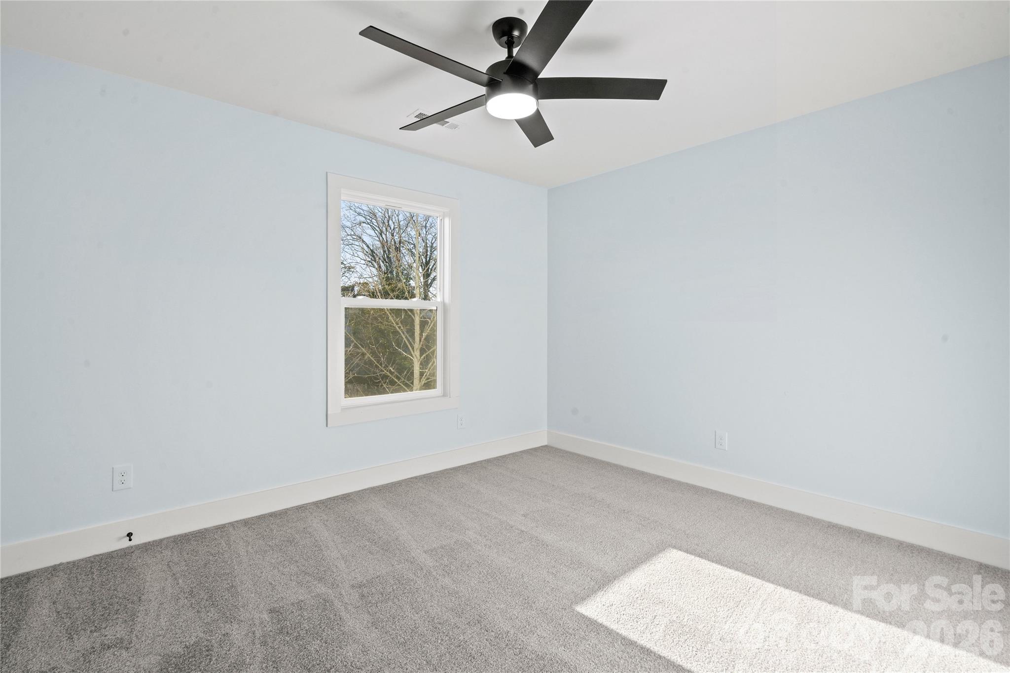 4524 Orphanage Road Concord, NC 28027 - Photo 8 of 29 an empty room with a window and a fan