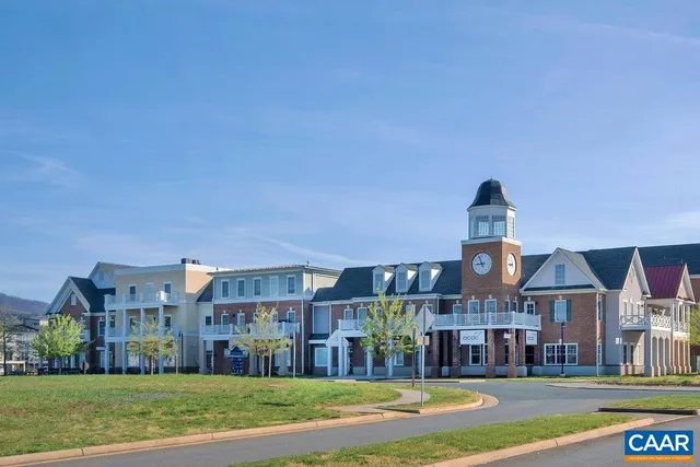 a front view of a building with trees