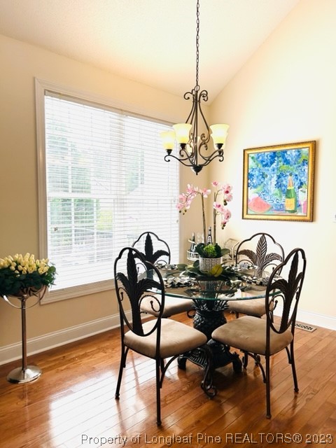 512 Maple Leaf Way Lumberton, NC 28358 - Photo 15 of 27 a dining room with furniture a chandelier and wooden floor