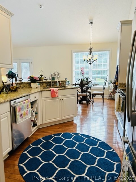 512 Maple Leaf Way Lumberton, NC 28358 - Photo 17 of 27 a kitchen with a table chairs and stove