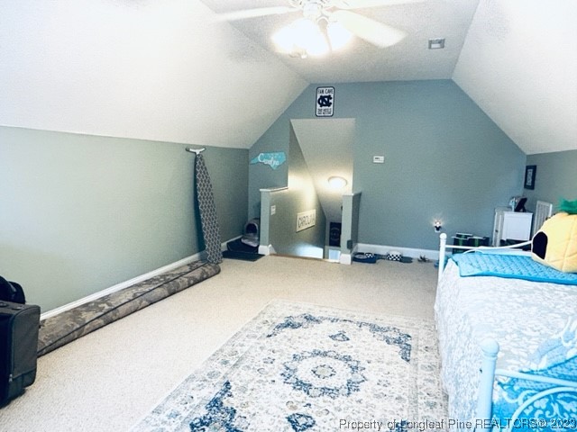 512 Maple Leaf Way Lumberton, NC 28358 - Photo 25 of 27 a bedroom with a bed and a chandelier