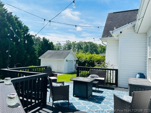 512 Maple Leaf Way Lumberton, NC 28358 - Photo 5 of 27 a roof deck with table and chairs