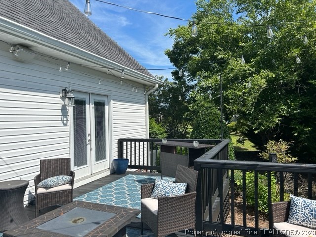 512 Maple Leaf Way Lumberton, NC 28358 - Photo 6 of 27 a view of a deck with chairs and wooden floor