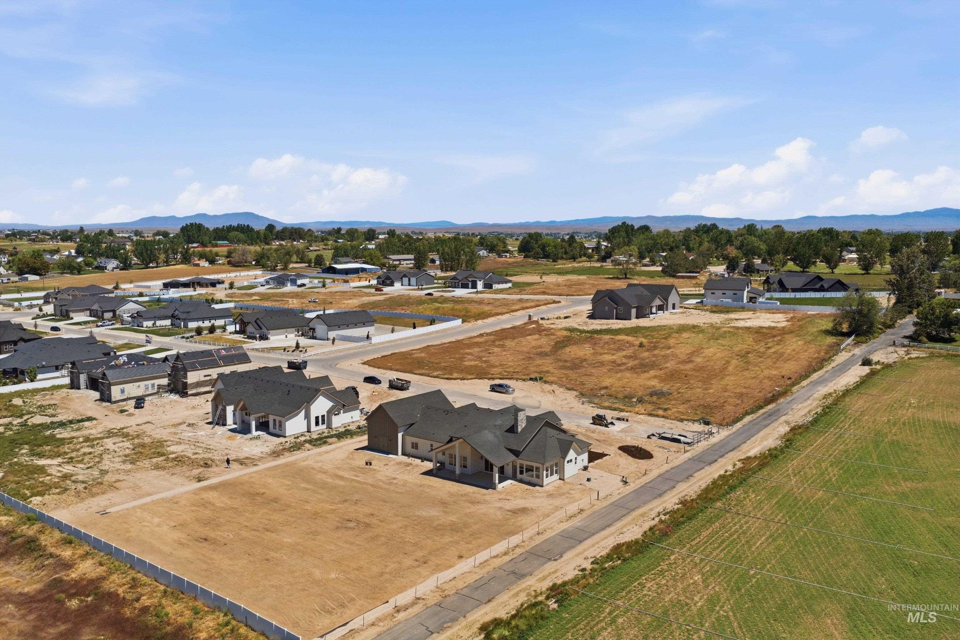 24763 Ardmore Court Caldwell, ID 83607 - Photo 45 of 50 Newly developed residential area featuring multiple single-story homes with dark pitched roofs and light-colored siding
