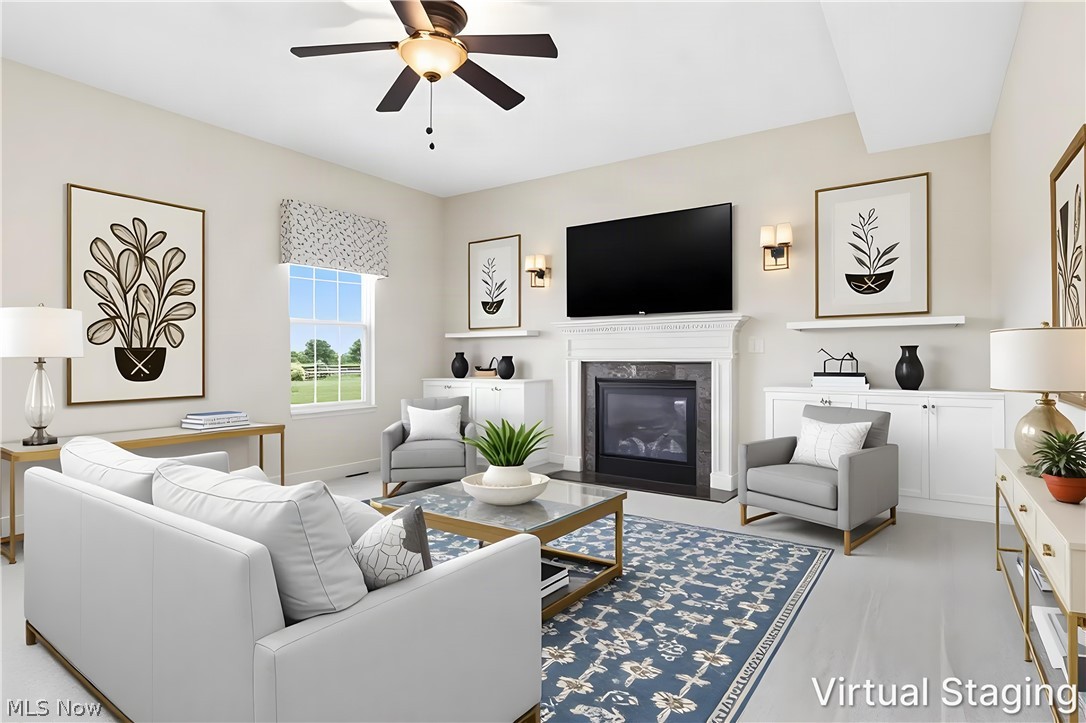 3280 Seven Bridges Road Medina, OH 44256 - Photo 10 of 41 Living area featuring a fireplace with a white mantel and dark surround, wood-finish flooring, a ceiling fan, a window, and built-in cabinetry