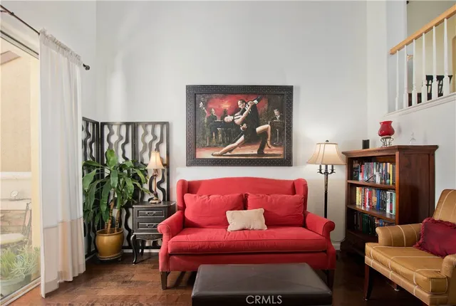 a living room with furniture and a book shelf