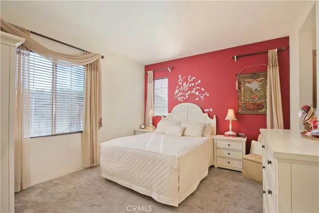a large bedroom with a bed and a dresser