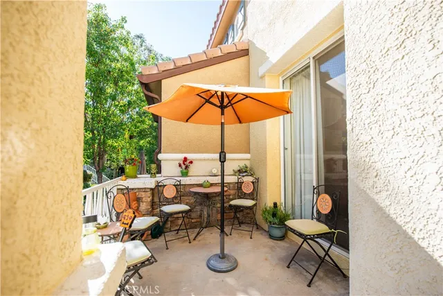 a view of a house with large windows and a small yard