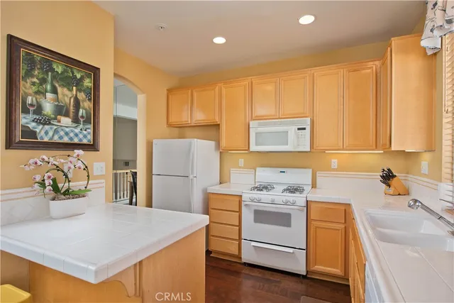 a kitchen with a stove a refrigerator and a sink