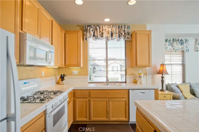 a kitchen with a sink stove top oven and cabinets
