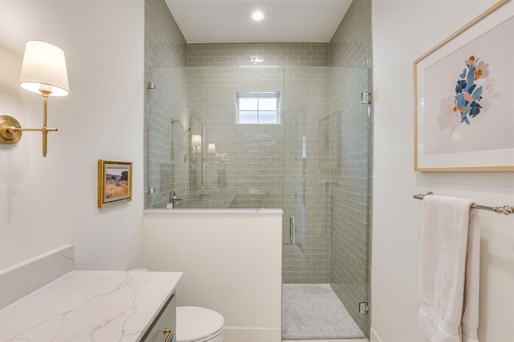 14000 Rozana Street Fort Worth, TX 76008 - Photo 24 of 38 a bathroom with a toilet a sink and mirror