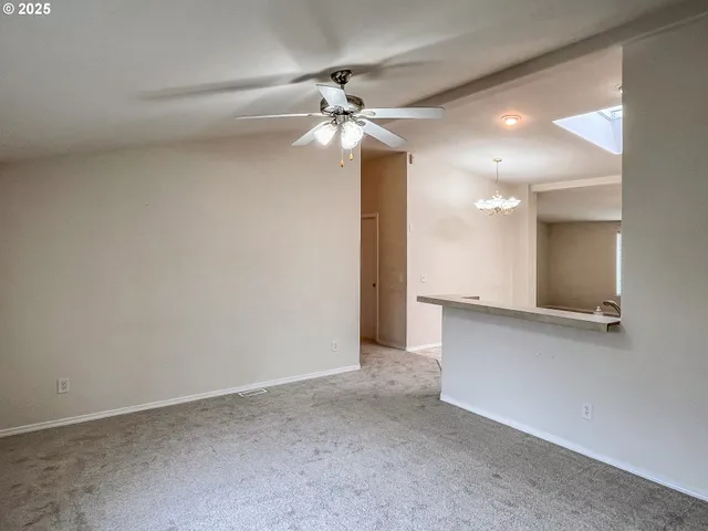 a view of an empty room with a ceiling fan