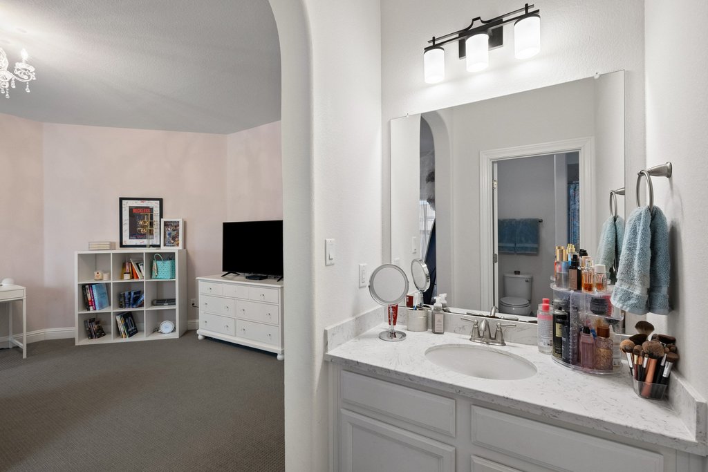 215 Lodestone Lane Austin, TX 78738 - Photo 32 of 40 A well-appointed vanity with a large mirror provides convenience between rooms.