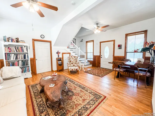 a living room with furniture and wooden floor