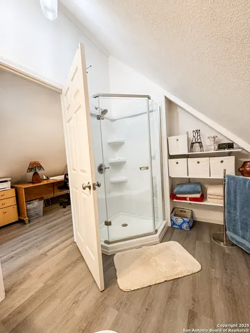 a bedroom with bed and a chandelier