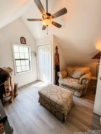 a bedroom with furniture and wooden floor