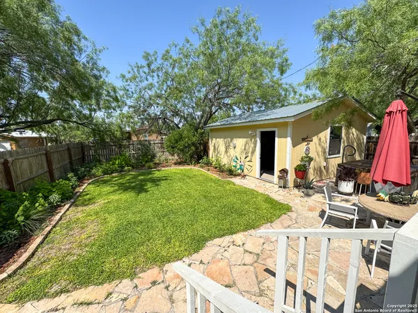 a view of backyard of house with green space