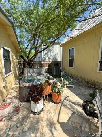 a view of backyard with swimming pool and porch