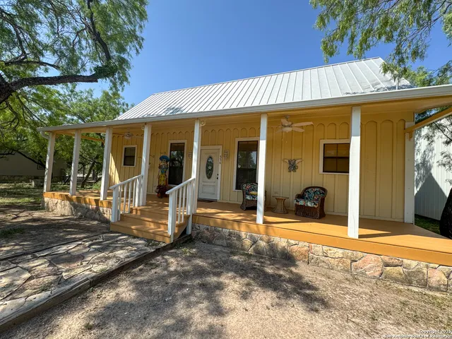 a view of a house with backyard porch and furniture