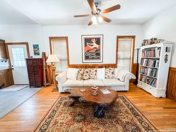 a living room with furniture and a book shelf