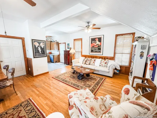 a bedroom with furniture and a wooden floor