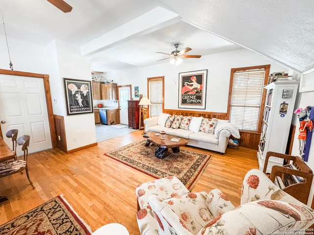 a bedroom with furniture and a wooden floor