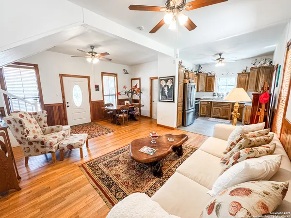 a living room with furniture and wooden floor