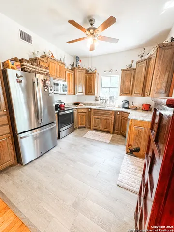 a kitchen with refrigerator and cabinets