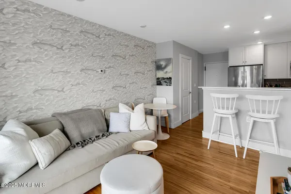 a living room with furniture and a wooden floor