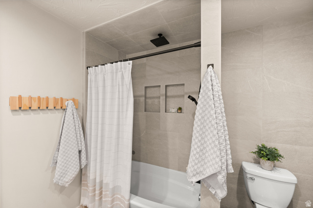 2163 Borg Drive Sandy, UT 84092 - Photo 19 of 31 Full bathroom with a combined bath / shower with rainfall shower and tile walls