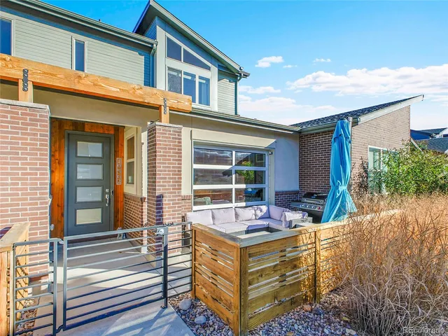 a view of house with a large window and wooden fence