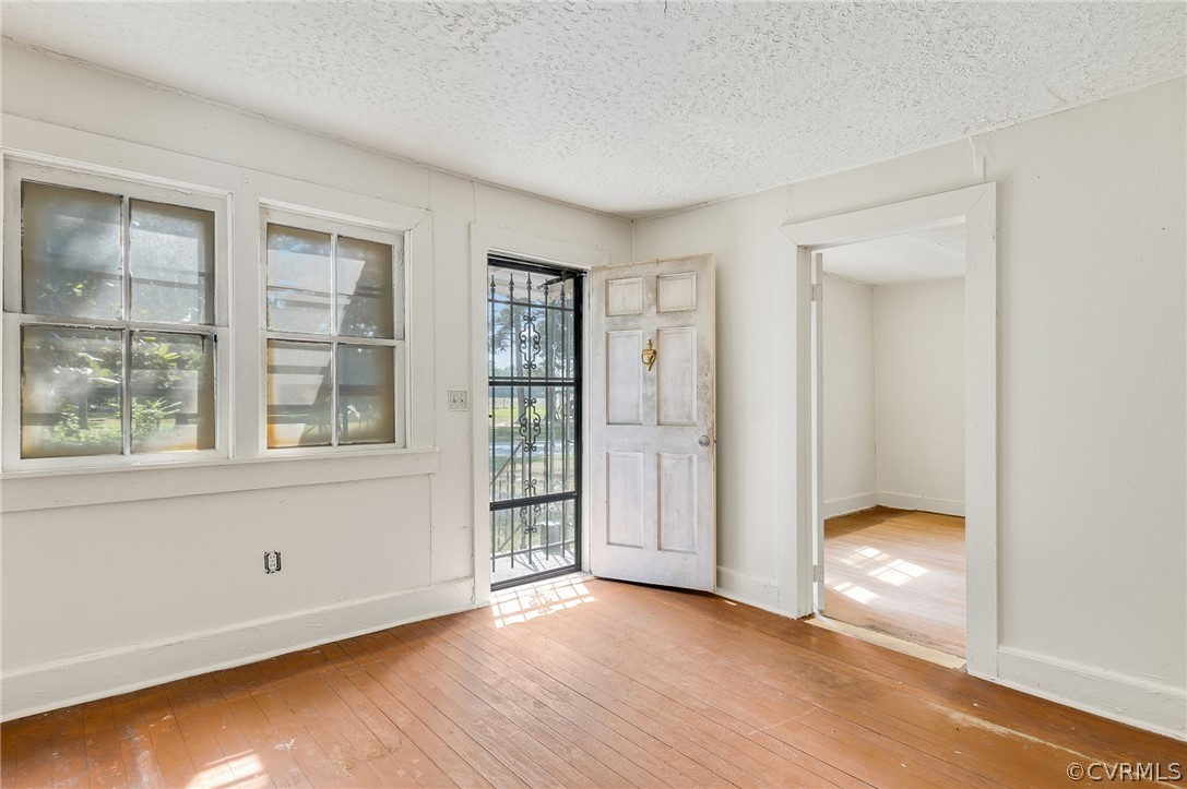 12313 Spiceley Road Ford, VA 23850 - Photo 4 of 17 an empty room with wooden floor and a window