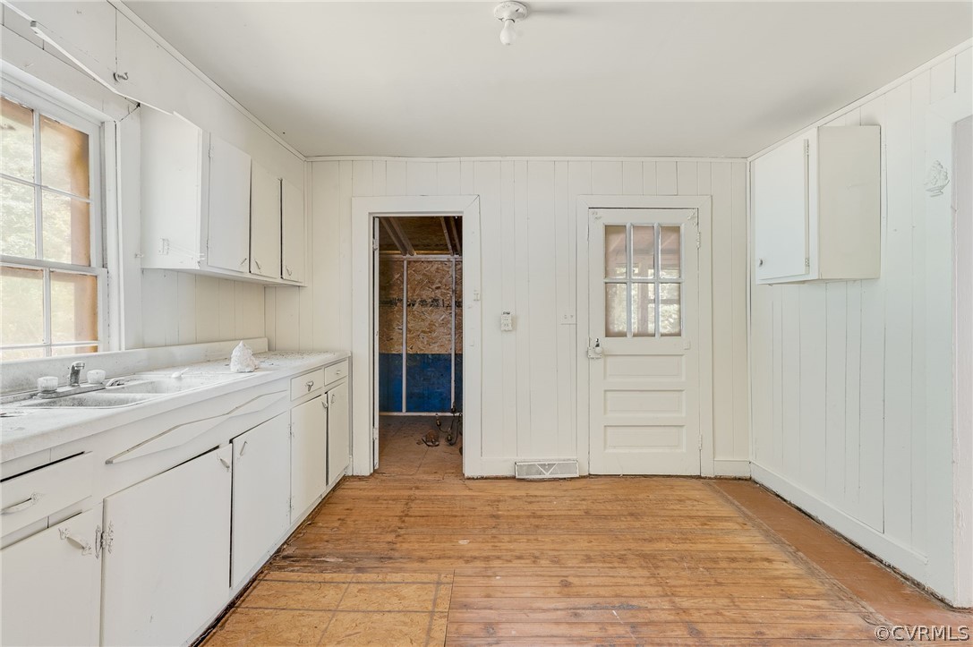 12313 Spiceley Road Ford, VA 23850 - Photo 8 of 17 a view of a kitchen with a sink and dishwasher with wooden floor