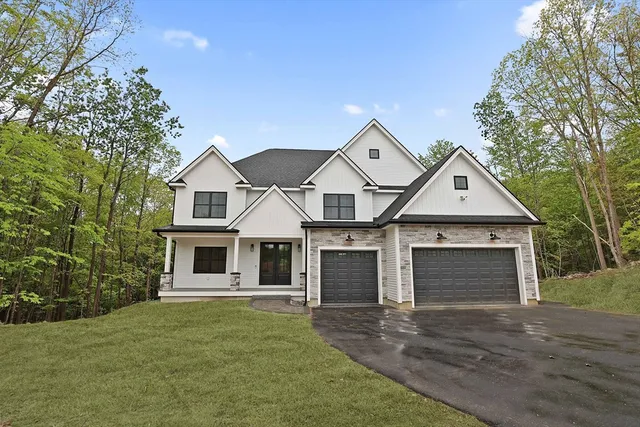 a front view of a house with a yard and garage