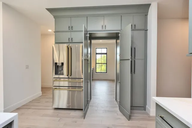 a kitchen with stainless steel appliances a refrigerator and cabinets