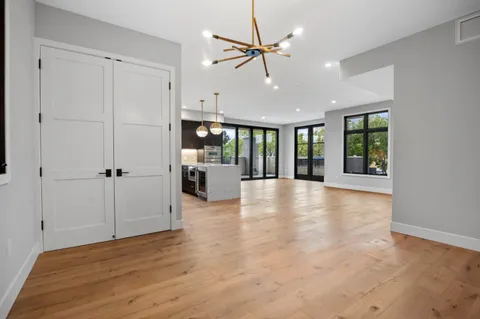a view of an entryway with wooden floor