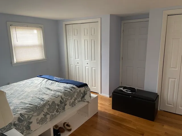 a bed sitting in a bedroom next to a window