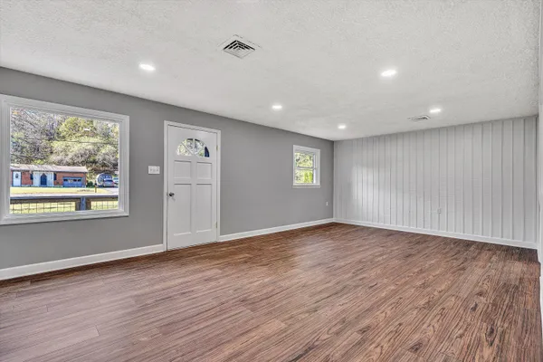a view of kitchen with wooden floor and electronic appliances