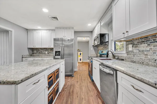 a view of room with wooden floor and window