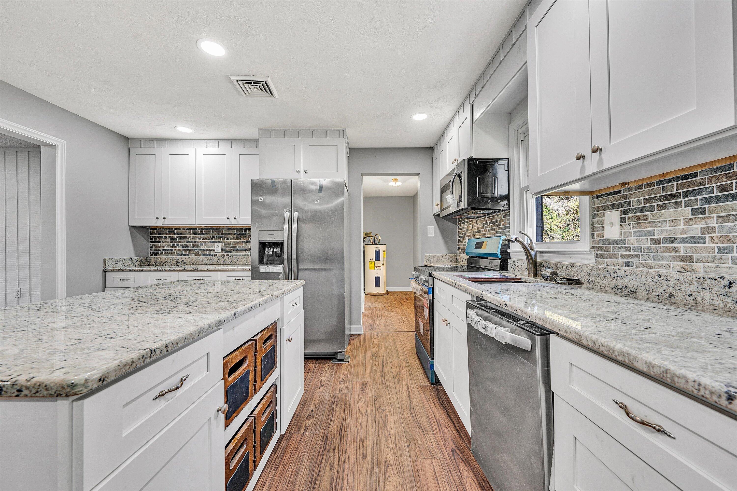 304 Broken Arrow Lane Covington, VA 24426 - Photo 18 of 46 a kitchen with stainless steel appliances granite countertop a sink stove and refrigerator