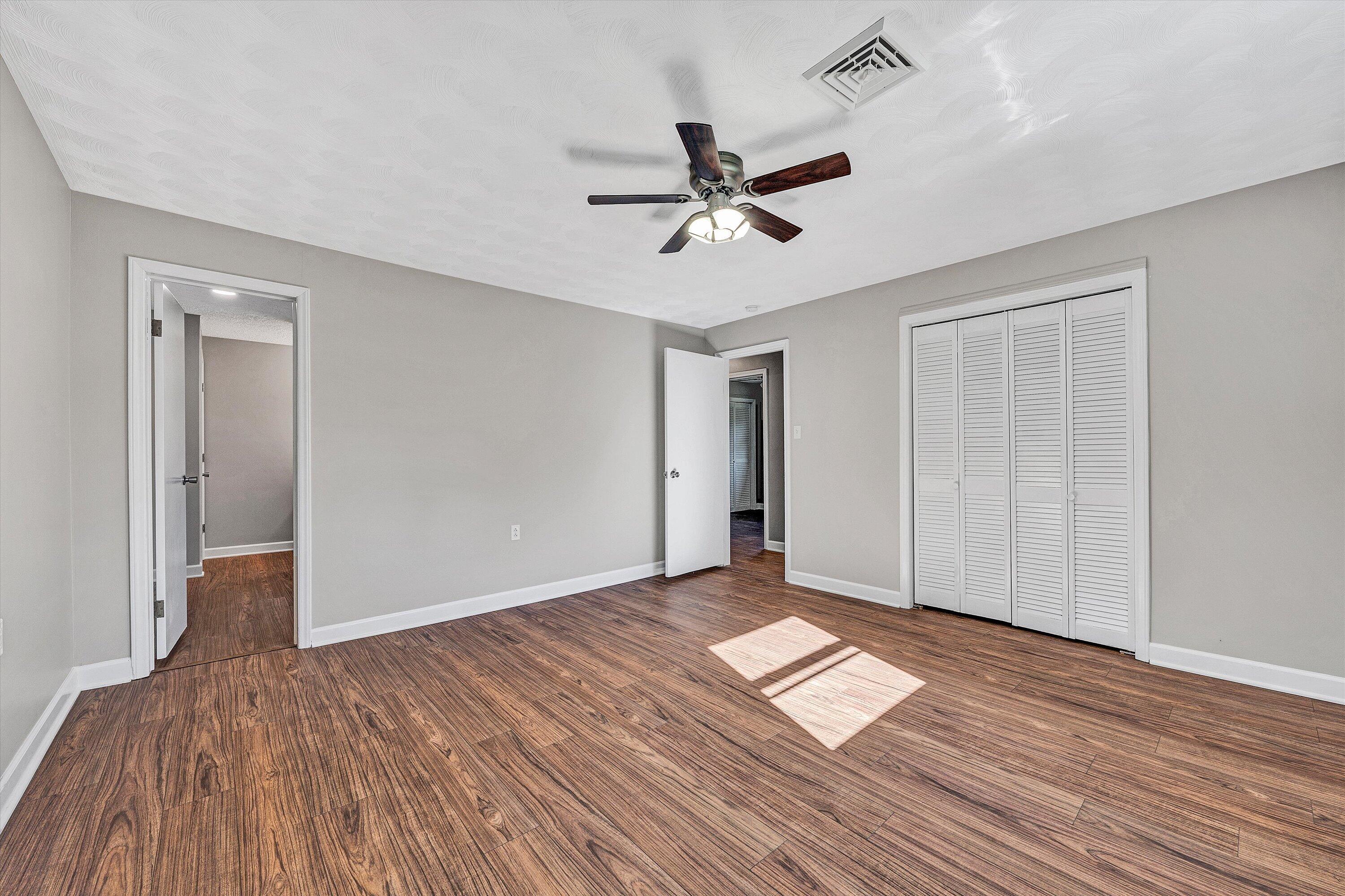 304 Broken Arrow Lane Covington, VA 24426 - Photo 27 of 46 a view of empty room with wooden floor and fan