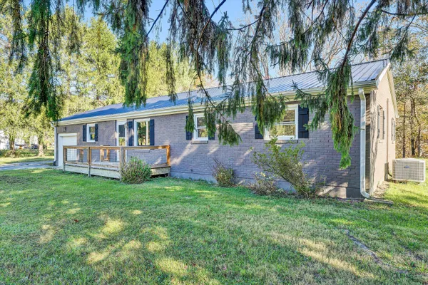 a view of a house with a yard and a garden